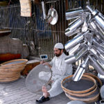 Craftsmen making handmade sieves and strainers mostly used to clean wheat flour and different food stuff on the roadside setup.