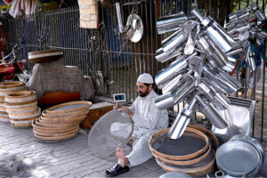 Craftsmen making handmade sieves and strainers mostly used to clean wheat flour and different food stuff on the roadside setup.