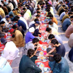 A large number of people breaking fast (Iftar) in the holy month of Ramazan ul Mubarak arranged by market shopkeeper.