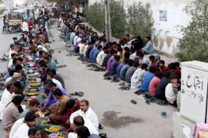 A large number of people break their fast at a free Iftar arrangement along the roadside in the holy month of Ramzan ul Mubarak at I-9 sector in the federal capital