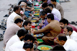 A large number of people break their fast at a free Iftar arrangement along the roadside in the holy month of Ramzan ul Mubarak at I-9 sector in the federal capital