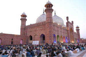 Faithfull waiting for the Azan e Maghrib to break their fast at the historical Mosque Badshahi Masjid during the Holy Fasting month of Ramzan-ul-Mubarak.