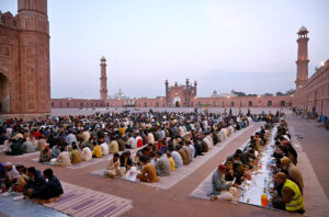 Faithfull waiting for the Azan e Maghrib to break their fast at the historical Mosque Badshahi Masjid during the Holy Fasting month of Ramzan-ul-Mubarak.