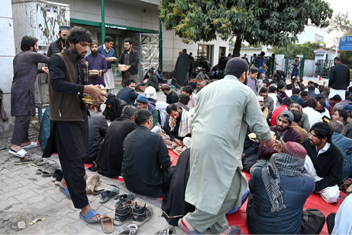 Volunteers serving free food to the fasting people during Iftar in the Islamic fasting month of Ramazan